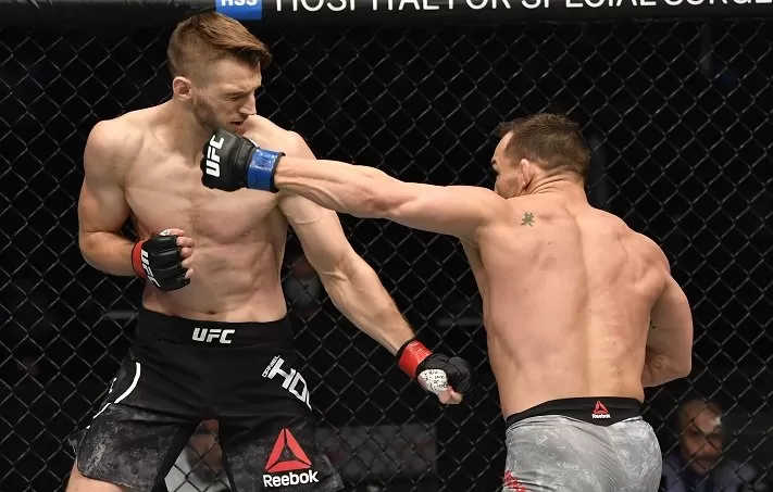 Michael Chandler lands on Dan Hooker during his UFC 257 debut in Abu Dhabi