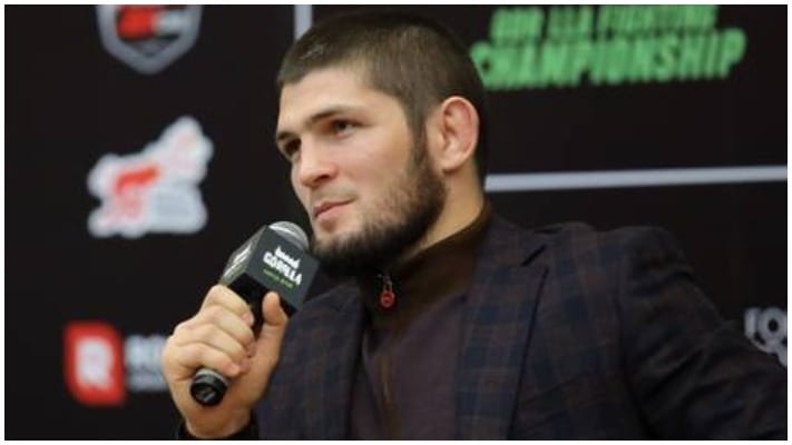 Khabib Nurmagomedov speaks into a microphone after announcing his promotion purchase