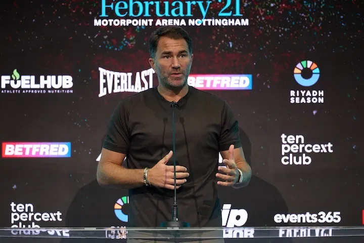 Eddie Hearn speaks at a Matchroom press conference podium