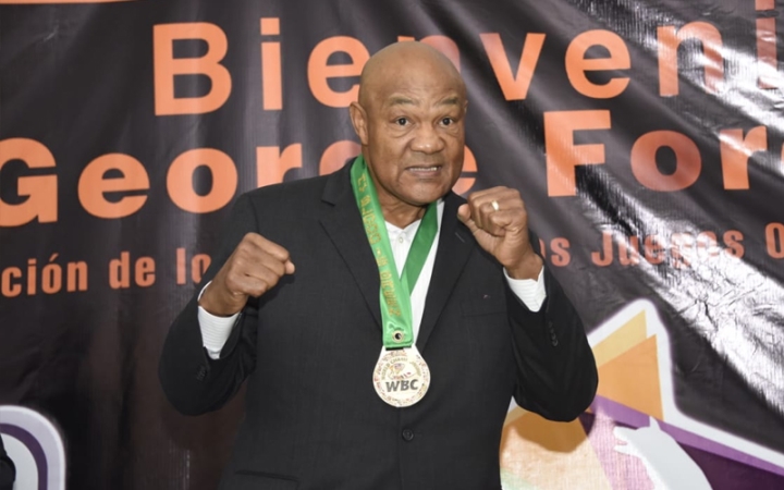 George Foreman poses with a WBC medal