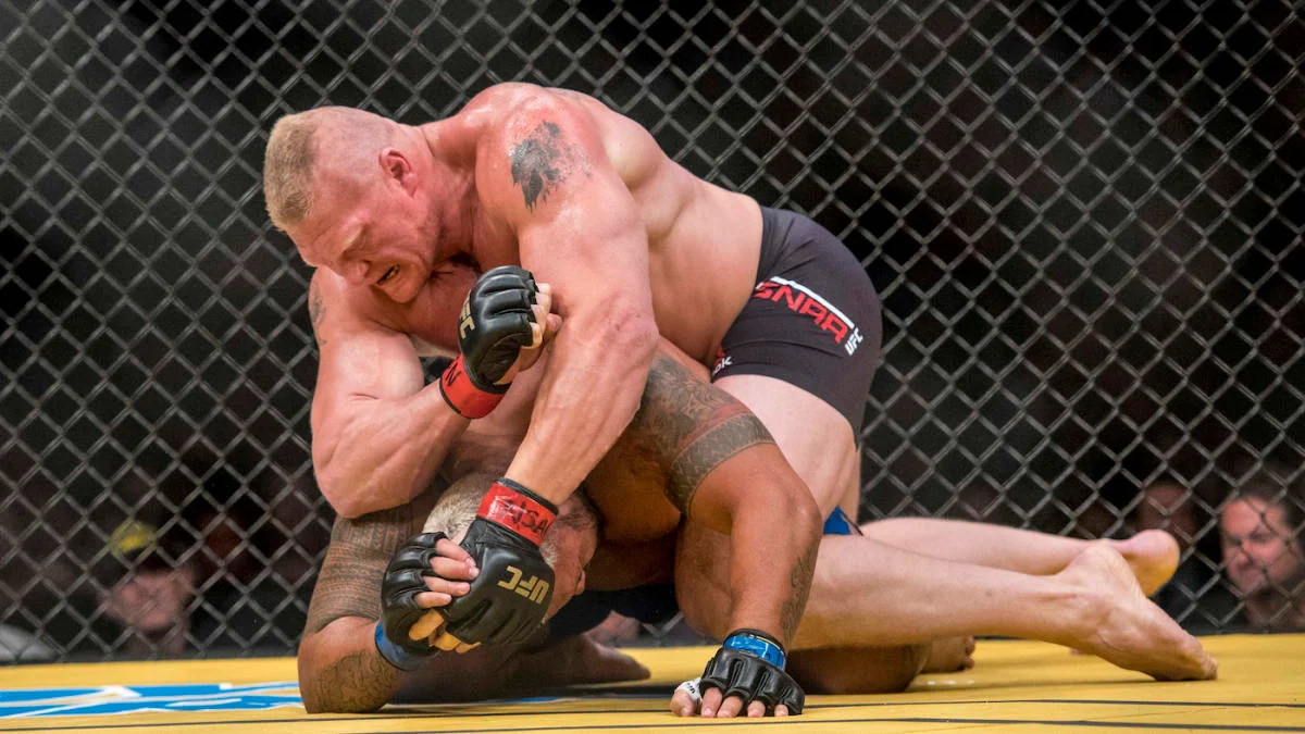 Brock Lesnar controls Mark Hunt on the mat at UFC 200