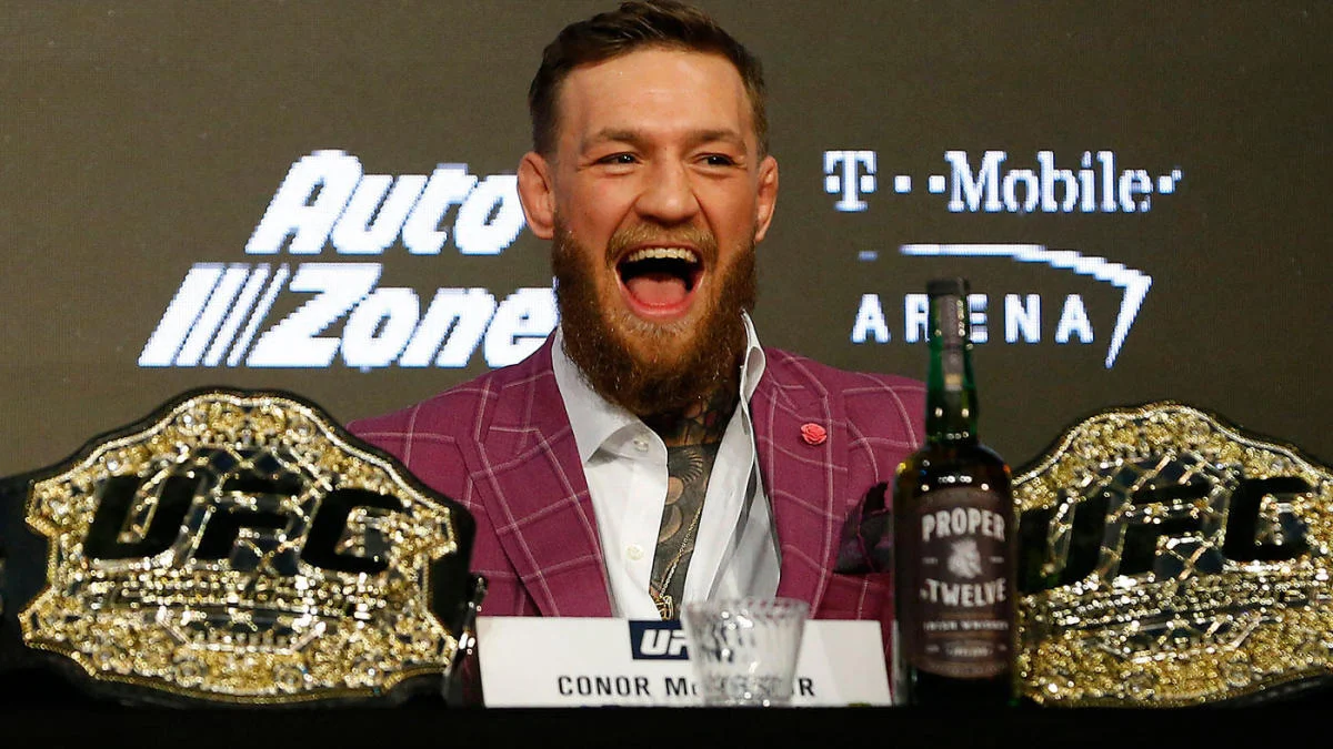 Conor McGregor holding the UFC featherweight and lightweight belts