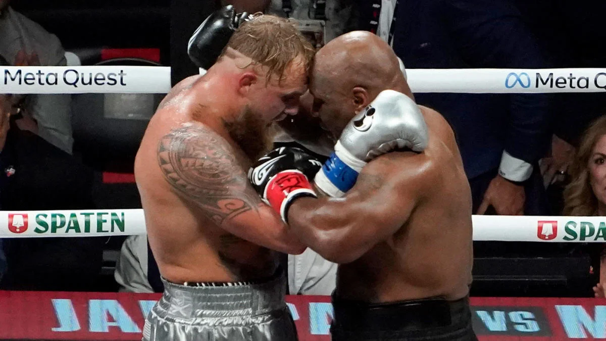 Mike Tyson and Jake Paul embrace after their fight