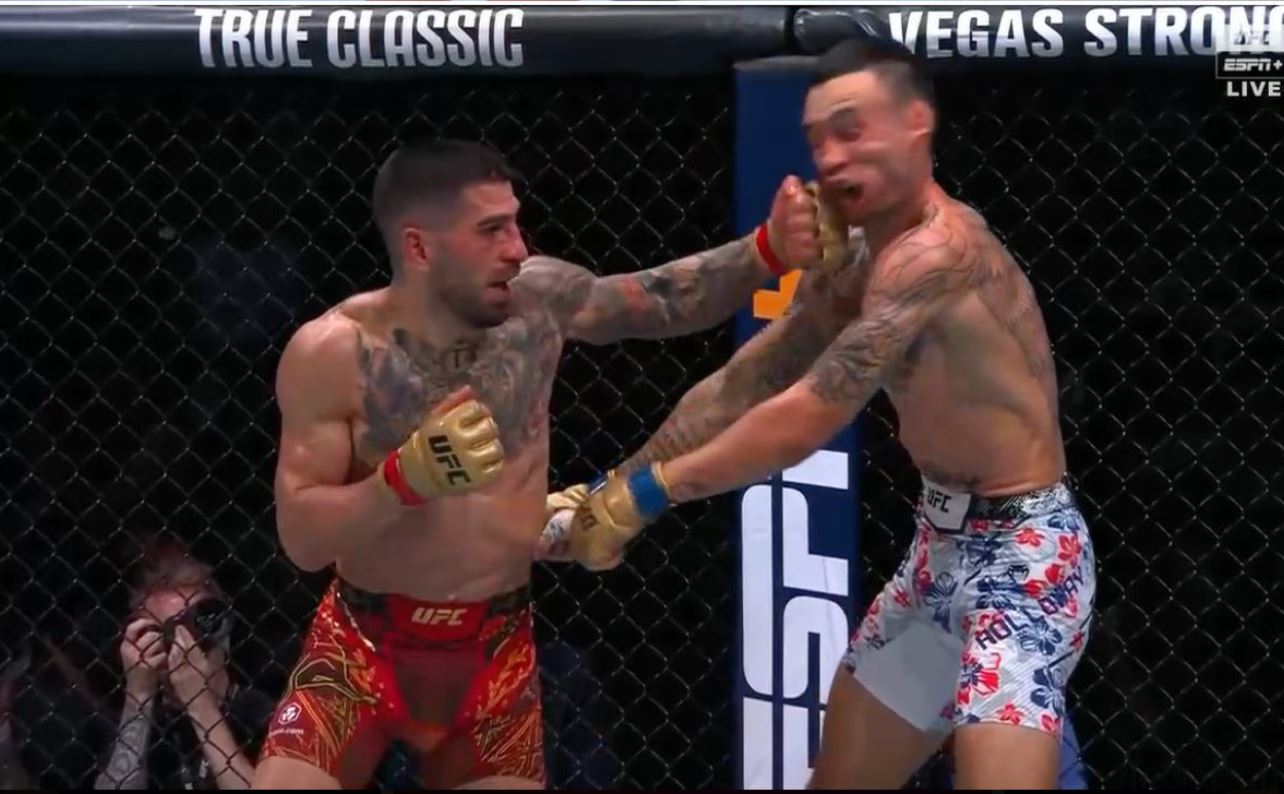 Ilia Topuria lands a punch on Max Holloway during their UFC 308 title fight in Abu Dhabi