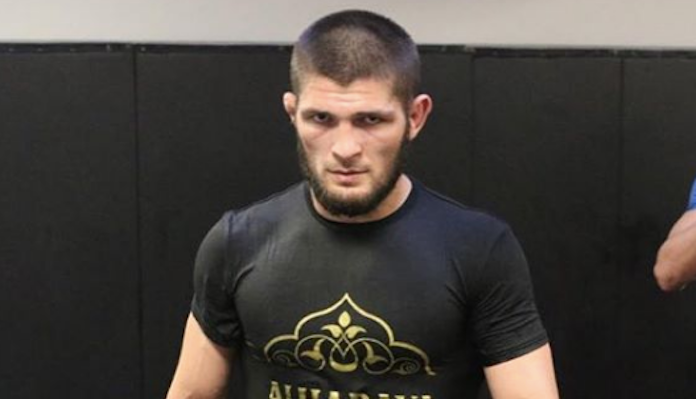 Khabib Nurmagomedov in a dark suit at a UFC press event