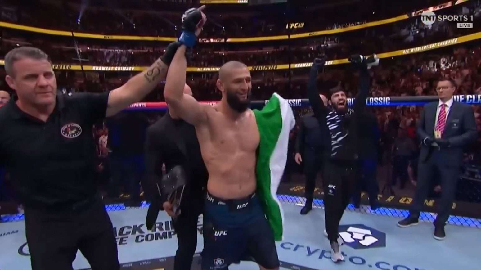 Khamzat Chimaev celebrates winning the middleweight title at UFC 319